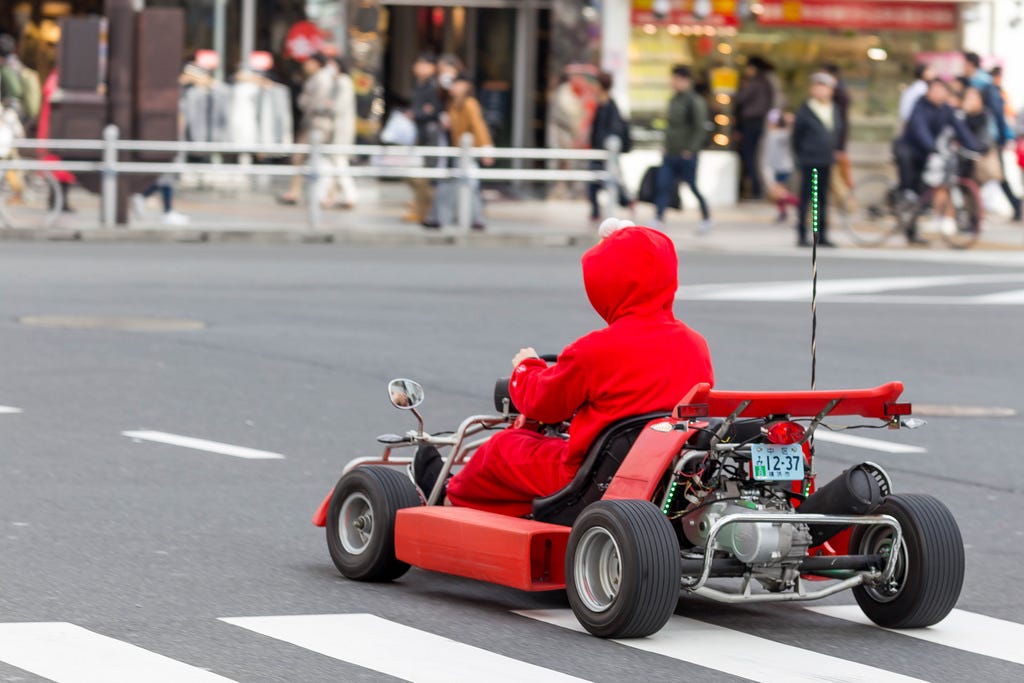 Mario Kart cosplayer in Tokyo waiting for the light to turn green.